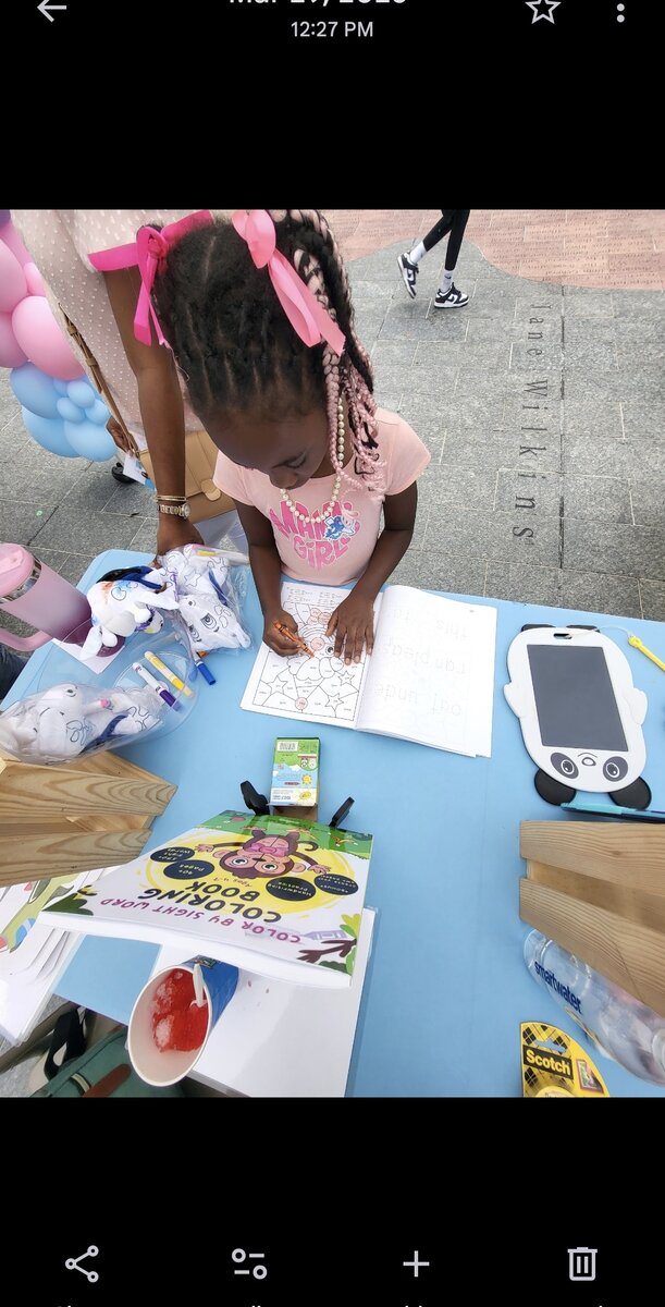 Child coloring at outdoor community event