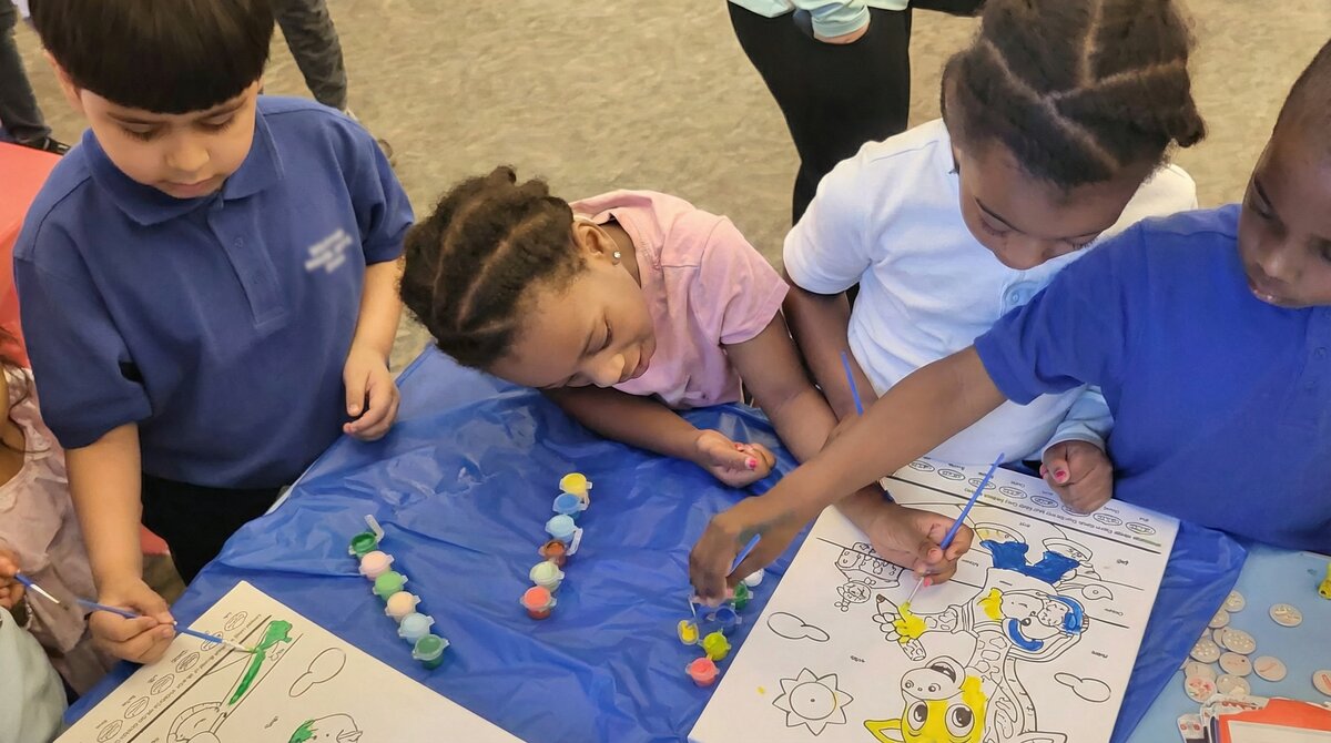 Children working together on Paint by Word coloring activities with manipulatives